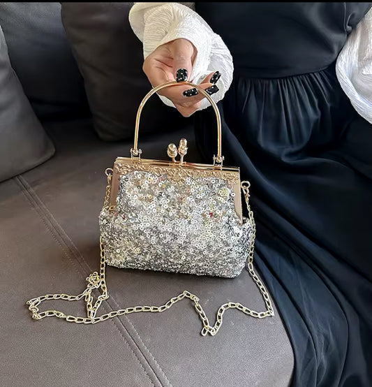 Bolso de fiesta resplandor para tonos plateados y dorados ,mango y cadena para colgar